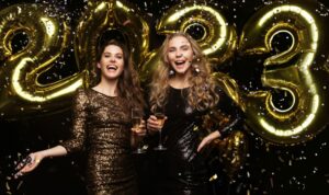 two-young-ladies-drinking-champagne-image-girls-with-balloons-isolated-black-background-having-fun-new-year-s-2023-eve-party-1068x634-1